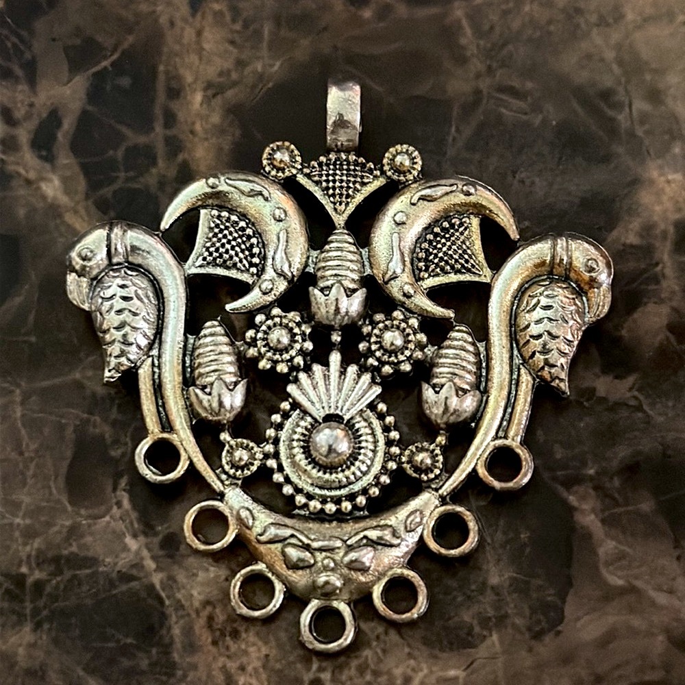 Pendant silvertone ornate holes on the bottom for beads top has large bale